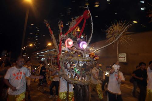 9月22日,香港薄扶林地區(qū)舉行舞火龍表演。舞火龍是香港中秋節(jié)最富傳統(tǒng)特色的習(xí)俗,80米長(zhǎng)的火龍龍身插滿了長(zhǎng)壽香,在龍鼓音樂(lè)配合下歡騰起舞。 新華社記者 呂小煒 攝