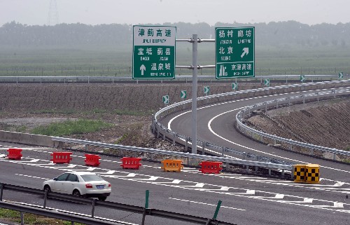 7月2日,一輛小轎車從京津高速和津薊高速公路的互通處駛過。目前,京津高速公路主線道路工程、橋梁工程,以及服務(wù)區(qū)、收費(fèi)站和停車區(qū)主體也已完工,即將實(shí)現(xiàn)全線通車。京津高速公路3年前開工建設(shè),北起北京朝陽區(qū)西直河,終點(diǎn)到達(dá)天津塘沽區(qū),全長(zhǎng)184.4公里。 新華社記者王曄彪攝