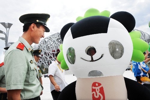 8月1日,一名小戰(zhàn)士正在與“福娃”晶晶“交流”。 當(dāng)日是“八一”建軍節(jié),擔(dān)任奧林匹克中心區(qū)安保任務(wù)的武警戰(zhàn)士們獲得十分鐘特許,一起在“鳥巢”前合影留念,度過了一個(gè)簡(jiǎn)樸又十分有意義的“八一”建軍節(jié)。 由于安保任務(wù)繁重,戰(zhàn)士們盡管在巡邏時(shí)已無數(shù)次路過“鳥巢”、“水立方”等場(chǎng)館,但獲準(zhǔn)與它們“親密接觸”、合影留念還是第一次。 新華社記者李紫恒攝