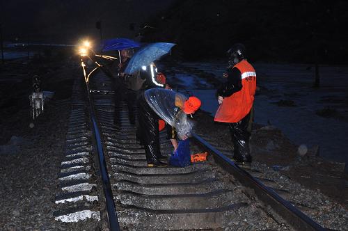 6月30日,剛剛修復通車的牡(丹江)密(山)鐵路北線再次遭遇洪澇災害,施工人員在現(xiàn)場看守。當日15時許,由于強降雨和山洪暴發(fā),黑龍江雞西新家站附近已經(jīng)修復的牡(丹江)密(山)鐵路北線兩處路基再次被洪水沖毀,五龍站附近一處路基被毀。洪災造成兩列火車被困,交通全部中斷。目前鐵路部門正全力調(diào)集人力物力進行搶修,并為旅客供應食品。 新華社發(fā)(張春祥 攝)
