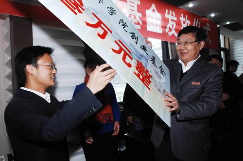 3月12日,襄樊學(xué)院領(lǐng)導(dǎo)為應(yīng)屆畢業(yè)生王杰(左)發(fā)放創(chuàng)業(yè)基金。 新華社發(fā)(安富斌 攝)
