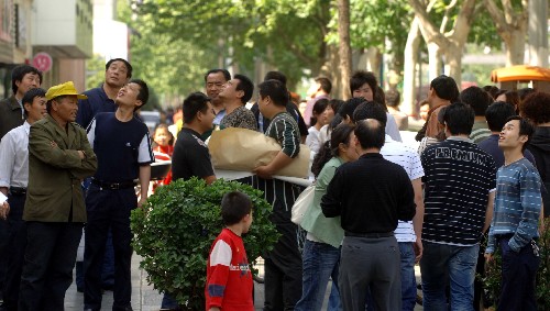 5月12日,河南鄭州震感明顯,市民在道路上躲避。 據(jù)國(guó)家地震臺(tái)網(wǎng)重新核定,北京時(shí)間5月12日14時(shí)28分,在四川汶川縣發(fā)生的地震震級(jí)為7.8級(jí)。 新華社記者岳月偉攝
