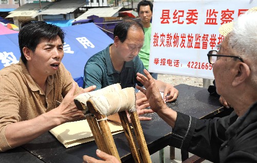陜西寧強(qiáng)委設(shè)立救災(zāi)款物發(fā)放監(jiān)督舉報(bào)流動(dòng)站 新華社照片,漢中(陜西),2008年6月3日 陜西寧強(qiáng)委設(shè)立救災(zāi)款物發(fā)放監(jiān)督舉報(bào)流動(dòng)站 6月3日,寧強(qiáng)縣紀(jì)委工作人員在陽(yáng)平關(guān)街道上接受群眾的咨詢和投訴。針對(duì)大量群眾轉(zhuǎn)移安置后居住分散的新形勢(shì),陜西省寧強(qiáng)縣紀(jì)檢部門(mén)派出專(zhuān)車(chē),作為救災(zāi)款物發(fā)放監(jiān)督舉報(bào)流動(dòng)站,在各鄉(xiāng)鎮(zhèn)巡回接訪,接受群眾投訴,確保救災(zāi)款物公平、透明、正確發(fā)放。寧強(qiáng)縣抗震救災(zāi)得到了政府和社會(huì)各界的大力支援,已收到上級(jí)下?lián)芫葹?zāi)資金3800多萬(wàn)元,還有帳篷、棉被、衣物、大米、面粉等大量物資。 新華社記者 陶明 攝