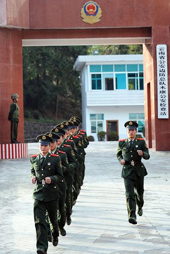 云南木康“緝毒先鋒站”——30年磨礪鑄就緝毒鋼鐵雄關(guān) 云南木康公安邊防檢查站的官兵列隊(duì)跑出大門,準(zhǔn)備換班(12月24日攝)。 云南木康公安邊防檢查站位于中緬邊境的云南德宏與保山龍陵的交界處,建于1978年,至今已經(jīng)30年。由于德宏毗鄰“金三角”地區(qū),販毒分子由此借道,導(dǎo)致毒品犯罪活動猖獗。木康檢查站的官兵在此戍邊守卡,不怕艱難困苦,不懼流血犧牲,投身禁毒事業(yè),與販毒分子斗智斗勇,生死較量。木康站的官兵每天檢查過往車輛2000余輛,平均每個(gè)官兵每天要搬動3噸貨物。30年來,木康站官兵共查緝各類毒品數(shù)十噸。2001年,國務(wù)院、中央軍委授予木康站“緝毒先鋒站”的榮譽(yù)稱號,木康站從此成為全國公安緝毒戰(zhàn)線上的一面旗幟。一代代的木康站官兵用青春和忠誠在祖國的西南邊陲鑄就了一道堅(jiān)不可破的鋼鐵雄關(guān)。 新華社記者 藺以光 攝