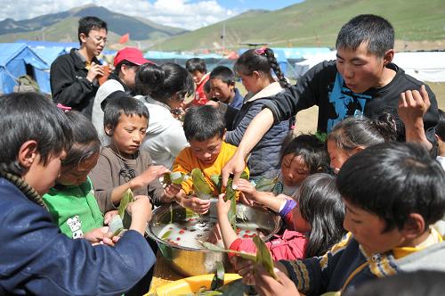玉樹(shù)災(zāi)區(qū)孤兒包粽子迎端午 6月15日,玉樹(shù)慈行喜愿孤兒院的孩子在老師的帶領(lǐng)下包粽子。 端午節(jié)來(lái)臨之際,玉樹(shù)慈行喜愿孤兒院的老師們帶著孩子們上了特殊的一課——包粽子。在老師手把手的指導(dǎo)下,孤兒院的孩子們拿起粽葉,像模像樣地包起了粽子。課后,他們還吃到了全國(guó)各地的志愿者為他們送來(lái)的“愛(ài)心粽子”。 新華社記者 吳光于 攝