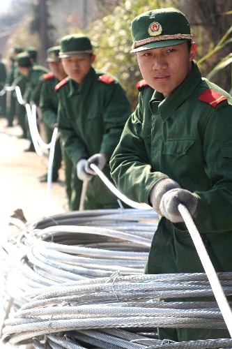 2月16日,武警戰(zhàn)士在建寧山區(qū)齊心協(xié)力拉電線。新華社發(fā)(李濤 攝)