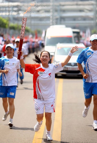 6月26日,奧運火炬手唐建莉手持火炬?zhèn)鬟f。當(dāng)日,北京奧運圣火在山西太原傳遞。 新華社記者邢廣利攝