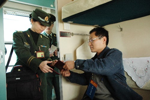 1月1日,邊防警察檢查旅客護(hù)照。新華社記者 向志強(qiáng) 攝