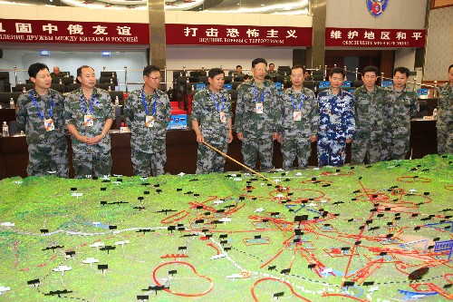 7月22日,總參作戰(zhàn)部副部長、中方副總導(dǎo)演孟國平(左四)在部署導(dǎo)調(diào)工作。新華社記者 查春明 攝