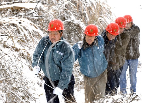 1月28日,宣城供電公司水東供電所員工冒著大雪搶修線路。