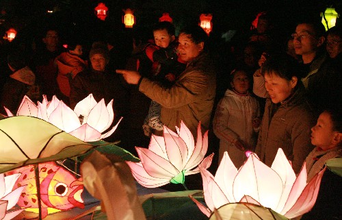 2月20日晚,人們?cè)谔K州古運(yùn)河畔駐足觀賞蓮花彩燈。當(dāng)日,“2008錦繡天堂元宵燈會(huì)”系列展演活動(dòng)在蘇州古運(yùn)河畔拉開(kāi)帷幕,現(xiàn)場(chǎng)舉行的賞花燈、猜燈謎等豐富多彩的民俗表演活動(dòng),吸引了近萬(wàn)市民和中外游客參與。 新華社發(fā)(王建中 攝)