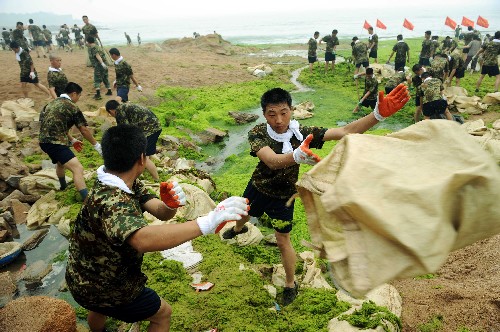 7月5日,駐青某海軍部隊用大型傳輸設(shè)備打撈滸苔。當日,各駐青部隊出動近5000多名官兵,參加“迎奧運清滸苔突擊日”活動,一天清理滸苔達6000余噸。截至目前,駐青部隊累計出動官兵5萬余人次,打撈青島近海滸苔20萬多噸。 新華社記者 范長國攝