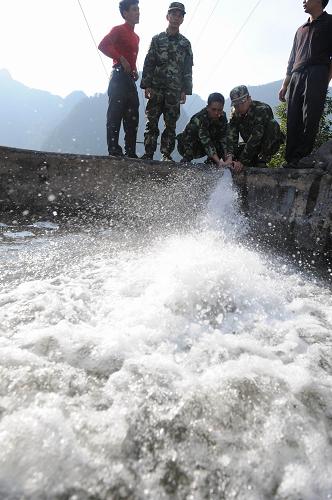在廣西東蘭縣東蘭鎮(zhèn)田洞村,消防官兵給集中供水點的水池注水(2月10日攝)。新華社記者 黃孝邦 攝