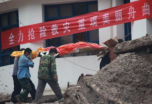 8月14日,遇難者親屬將救援部隊(duì)清理干凈的遇難者遺體運(yùn)走。新華社記者 李剛 攝