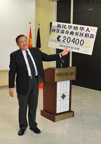 8月19日,在比利時(shí)首都布魯塞爾,中國(guó)駐比利時(shí)大使張?jiān)h(yuǎn)在捐款儀式上手持捐款支票模板向華僑華人表示感謝。新華社記者 武巍 攝