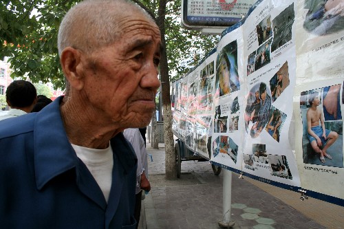 6月26日,一位隴南市市民在禁毒宣傳展板前。 當日是“6·26”國際禁毒日,正在全力抗震救災的甘肅省隴南市武都區(qū)公安部門,抽調人員舉辦禁毒宣傳展覽,吸引了眾多市民前來觀看。 新華社記者 屠國璽 攝