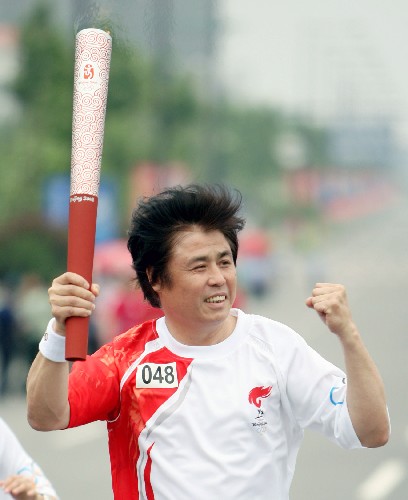 5月28日,奧運(yùn)火炬手張國(guó)琳手持火炬?zhèn)鬟f。當(dāng)日,北京奧運(yùn)會(huì)圣火在安徽合肥傳遞。 新華社記者 邢廣利 攝