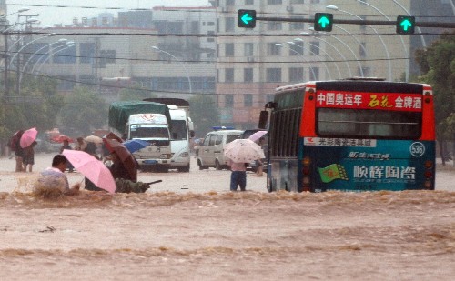 7月22日,湖北襄樊市環(huán)山路積水嚴(yán)重,行人和汽車在積水中艱難前行。當(dāng)日,湖北襄樊遭遇強(qiáng)降雨,城區(qū)多處低洼地段出現(xiàn)內(nèi)澇,給居民出行造成不便。 新華社發(fā)