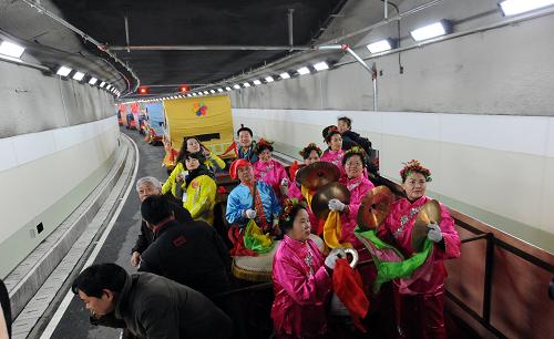 12月28日,建設(shè)單位組織的車隊(duì)通過(guò)隧道。 新華社記者 程敏 攝