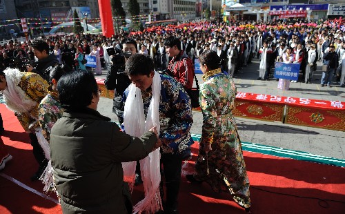 3月2日,在康定縣城情歌廣場,當(dāng)?shù)仡I(lǐng)導(dǎo)向藏族農(nóng)牧民子女代表獻(xiàn)哈達(dá)鼓勵(lì)他們好好學(xué)習(xí)。 新華社記者 江宏景 攝