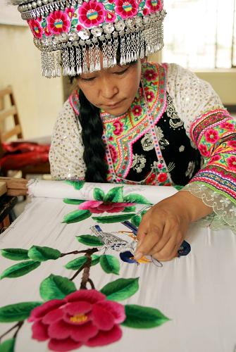 8月14日,一名彝族婦女展示彝族傳統(tǒng)刺繡工藝。當(dāng)日是我國彝族同胞一年中最盛大的傳統(tǒng)節(jié)日火把節(jié)。云南省楚雄彝族自治州工人文化宮正在舉辦的“秀美彝鄉(xiāng)——三街彝族刺繡展”讓市民和游客的節(jié)日生活更加豐富多彩,參展的350件精美彝族傳統(tǒng)刺繡作品均出自楚雄三街鎮(zhèn)142名彝族婦女之手。新華社記者 施思思攝