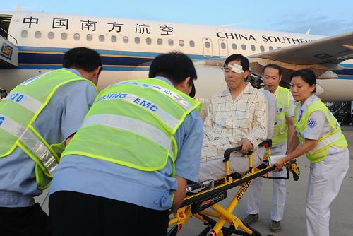 8月27日,剛剛飛抵首都國際機(jī)場(chǎng)的伊春空難傷員由醫(yī)護(hù)人員送往醫(yī)院救治。新華社發(fā)