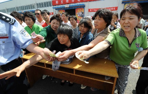 6月1日,北京市民爭(zhēng)相購(gòu)買義賣商品。當(dāng)日,北京市民政局在北京新發(fā)地農(nóng)貿(mào)市場(chǎng)組織大型義賣活動(dòng),義賣所得款項(xiàng)將全部用來(lái)購(gòu)置書包、文具等學(xué)習(xí)用品,送給地震災(zāi)區(qū)的學(xué)生。新發(fā)地農(nóng)貿(mào)市場(chǎng)是北京大型農(nóng)貿(mào)產(chǎn)品批發(fā)市場(chǎng)之一,義賣商品全部是由市場(chǎng)商戶提供。 新華社記者 李文攝