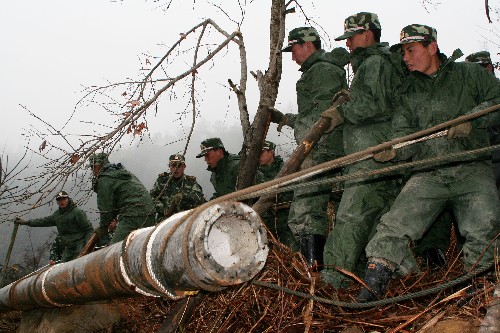 2月18日,武警官兵冒雨在建寧縣山區(qū)抬運(yùn)電線桿。 因冰凍災(zāi)害影響,福建省建寧縣、寧化縣的電力設(shè)施遭到嚴(yán)重破壞,為了讓災(zāi)區(qū)群眾能在元宵節(jié)前用上電,武警福建省總隊(duì)千余名官兵正在全力以赴協(xié)助電力部門搶修受損線路。 新華社發(fā)(李濤 攝)