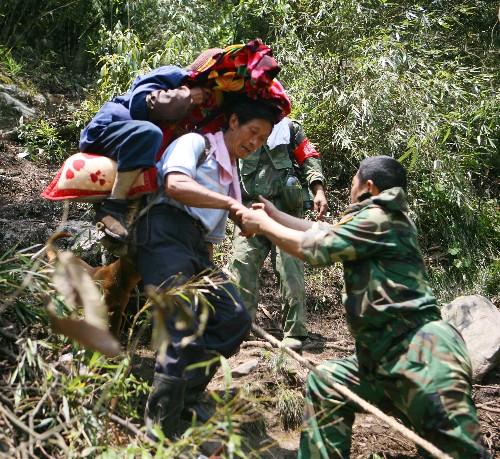 5月19日,民兵突擊隊(duì)員們幫助災(zāi)民下山。當(dāng)日,四川內(nèi)江軍分區(qū)第三批38名民兵突擊隊(duì)員每人背負(fù)約20公斤救災(zāi)物資,克服重重困難,歷時(shí)近10個(gè)小時(shí),進(jìn)入曾一度與外界失去聯(lián)系的四川省綿陽市安縣茶坪鄉(xiāng),將救災(zāi)物資送到了災(zāi)民手中,并幫助災(zāi)民安全轉(zhuǎn)移。 新華社發(fā)(劉忠俊 攝)
