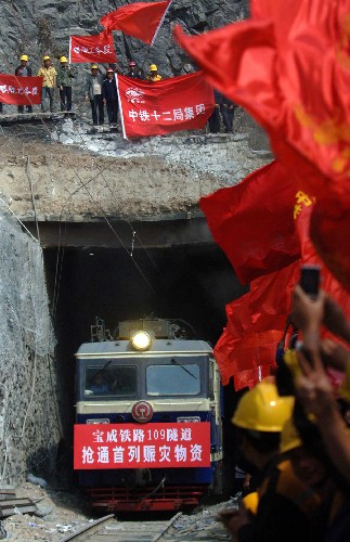 5月24日10時,滿載運往四川地震災區(qū)救災物資的搶977次列車,從寶成鐵路徽縣至虞關間的109隧道順利通過,這標志著已中斷行車283小時的寶成鐵路全線恢復通車。 寶成鐵路是中國西北通向西南的大動脈,擔負著向四川災區(qū)運送人員和物資的重要任務。5月12日14時28分,因四川汶川大地震,引發(fā)寶成線109號隧道山體塌方,致使21043次貨物列車在隧道內脫線,油罐車起火燃燒,寶成線因此中斷行車。 新華社記者丁海濤攝