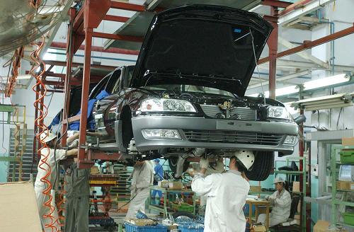 這是東風(fēng)汽車公司襄樊乘用車基地的工人在安裝汽車零件(2003年9月2日拍攝)。 新華社發(fā)