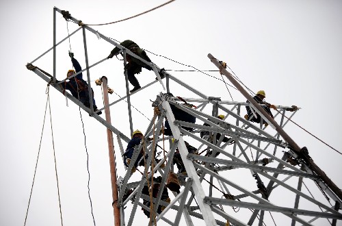 2月6日,河南省電力公司工程人員在湖南郴州搭建新塔。 持續(xù)的暴雪、罕見(jiàn)的冰凍……2008年開(kāi)年,一場(chǎng)罕見(jiàn)的雨雪冰凍災(zāi)害急速侵襲南方各省。世界,將關(guān)注的目光投向中國(guó)。鐵塔倒塌、線路停運(yùn),湖南郴州陷入黑暗、貴州電網(wǎng)解列運(yùn)行,華東告急、華中告急……連日來(lái),前所未有的電力危情使人民群眾的正常生活和經(jīng)濟(jì)運(yùn)行遭受巨大威脅。人們向電力投來(lái)焦灼與關(guān)注的目光。 在中共中央、國(guó)務(wù)院的部署和指揮下,“中國(guó)電力”緊急應(yīng)變,迅速行動(dòng),全力投入“抗冰保電”的戰(zhàn)斗中