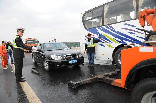 12月16日,高速執(zhí)法人員在演練中指揮拖車將“事故車輛”拖離現(xiàn)場(chǎng)。新華社記者 陳誠(chéng) 攝