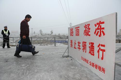 1月5日,由于進(jìn)入萬(wàn)山城內(nèi)的主要道路已經(jīng)封閉,人們只能步行入城。截至1月5日,貴州省萬(wàn)山特區(qū)凝凍天氣已持續(xù)5天,當(dāng)?shù)厥転?zāi)人員達(dá)4899人,直接經(jīng)濟(jì)損失689萬(wàn)元。全區(qū)70%的供水支管凝凍無(wú)法正常供水。目前,通往萬(wàn)山特區(qū)城區(qū)的主要道路也已封閉達(dá)5天。新華社記者 劉續(xù) 攝