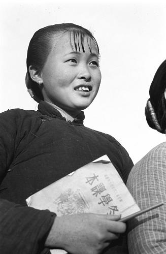 圖為挾著課本上學(xué)去的農(nóng)村婦女。 新華社記者 王純德 攝(資料照片)