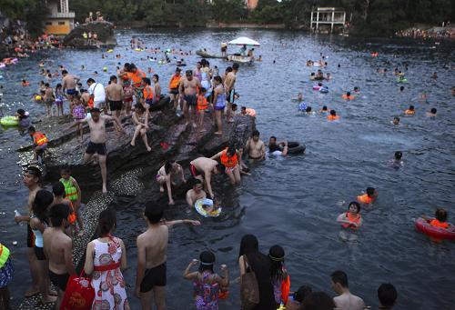 7月4日,眾多市民和游客在廣西靈水風(fēng)景區(qū)戲水。近日,廣西出現(xiàn)今年第一輪大范圍高溫晴熱天氣,南寧市郊避暑勝地靈水風(fēng)景區(qū)迎來消暑納涼人流高峰。新華社發(fā)(馬震宇 攝)