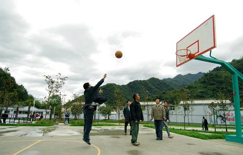 10月10日,甘肅康縣岸門口鎮(zhèn)青崗壩村的村民正在新建的村級(jí)文化活動(dòng)廣場(chǎng)上打籃球。甘肅隴南地震災(zāi)區(qū)將災(zāi)后重建與生態(tài)文明緊密結(jié)合。目前,隴南市康縣104個(gè)生態(tài)文明示范點(diǎn)共栽植綠化樹(shù)木71744株,綠化空地、院落30389平方米;新建沼氣池266座,垃圾池986個(gè),設(shè)施垃圾箱922個(gè),村級(jí)文化活動(dòng)廣場(chǎng)10個(gè),安裝健身器材55個(gè),小花園678個(gè)。目前,隴南市森林面積由生態(tài)保護(hù)前的1452萬(wàn)畝增加到1758萬(wàn)畝,覆蓋率由37.5%提高到42.01%。新華社記者 高健鈞 攝