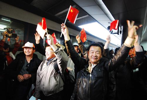 3月3日,在江西南昌火車(chē)站,從利比亞撤至埃及回國(guó)的江西南昌籍工人們激動(dòng)地向迎接的人們揮舞國(guó)旗。當(dāng)日7時(shí)30分許,從利比亞撤至埃及后乘坐國(guó)航包機(jī)從開(kāi)羅機(jī)場(chǎng)回國(guó)的148名江西同胞乘坐Z67次北京西至南昌的列車(chē)抵達(dá)南昌,平安返鄉(xiāng)。新華社發(fā)(胡國(guó)林 攝)