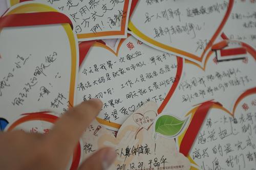 6月14日,一名獻(xiàn)血者在查看北京西單獻(xiàn)血站內(nèi)墻壁上貼著的獻(xiàn)血者留言。當(dāng)日是第9個(gè)世界獻(xiàn)血日,今年獻(xiàn)血日的主題是“每位獻(xiàn)血者都是英雄”。新華社發(fā)(劉長龍 攝)