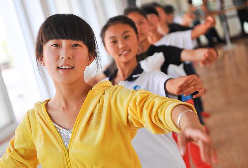 定邊中學(xué)的學(xué)生在舞蹈課上進(jìn)行訓(xùn)練。陜西省定邊縣位于陜甘寧和內(nèi)蒙古四省區(qū)交界,是黃土高原與荒漠草原的過渡地帶,由于十年九旱、風(fēng)沙肆虐,這里一度是陜西最貧困落后的地區(qū)之一,因為貧困,許多人失去了接受良好教育,改變命運的機(jī)會。近幾年來,定邊依托當(dāng)?shù)刎S富的石油、天然氣等自然資源使經(jīng)濟(jì)快速發(fā)展,當(dāng)?shù)卣膊粩嗉訌?qiáng)對教育的投入,“十一五”以來總計投資24.5億元用于改善縣城及農(nóng)村校園基礎(chǔ)設(shè)施建設(shè)、加大優(yōu)秀人才引進(jìn)、全面推進(jìn)素質(zhì)教育。如今,這個昔日窮苦縣城的學(xué)生們也能像大城市的孩子們一樣,享受到優(yōu)質(zhì)的教育資源。新華社記者 劉瀟 攝