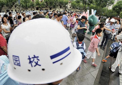 9月2日早晨,在上海市靜安區(qū)第一師范學(xué)校附屬小學(xué)門口,校園保安和護(hù)校警察在負(fù)責(zé)到校學(xué)生的安全。新華社記者 劉穎 攝