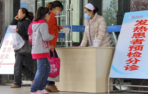 4月23日,在棗莊市立醫(yī)院,市民在“發(fā)熱患者預檢分診”標識牌旁咨詢。新華社發(fā)