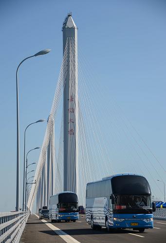 7月18日,參加通車儀式的車輛行駛在橋面上。新華社記者徐昱攝