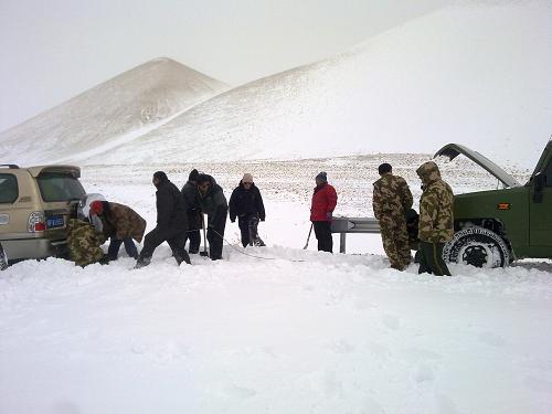 2月16日,武警交通八支隊隊員幫助群眾拖出陷入雪地的車輛。新華社 發(fā)