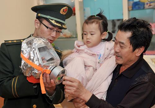 11月15日,重慶市榮昌縣消防大隊的一名消防戰(zhàn)士在一高層建筑居民家中向住戶講解消防知識,傳授防煙面罩使用技巧。當日,為增強高層住戶的防火意識,提高火災發(fā)生時的自救能力,重慶市榮昌縣消防大隊針對轄區(qū)80多棟高層建筑啟動了“珍愛生命,從我做起”消防安全宣傳活動。消防戰(zhàn)士們深入到高層住戶家中、居民社區(qū)、幼兒園等地,開展消防宣傳,并向高層住戶們無償發(fā)放了2500多具防煙面罩。據(jù)了解,防煙面罩可有效防止?jié)鉄煂θ梭w的危害,將普通人在火災濃煙熏蒸下的生存時間提高到40分鐘。新華社記者 劉潺 攝