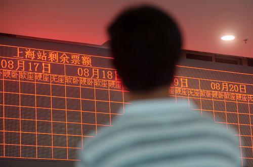 8月11日,旅客在鐵路上海站售票大廳觀看售票信息。新華社發(fā)(鈕一新 攝)