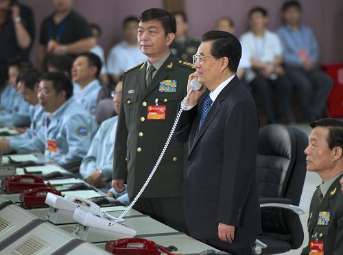 6月26日,中共中央總書記、國家主席、中央軍委主席胡錦濤在北京航天飛行控制中心,同神舟九號航天員景海鵬、劉旺、劉洋親切通話。 新華社記者 馬占成 攝