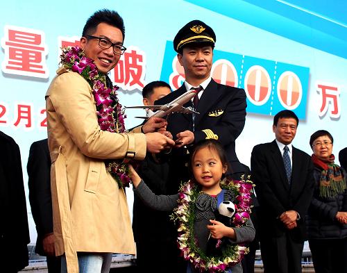 12月20日,東航機(jī)長(zhǎng)向旅客林偉(前左一)贈(zèng)送飛機(jī)模型。當(dāng)日,由上海飛往紐約的東航旅客林偉幸運(yùn)地成為上海機(jī)場(chǎng)今年第8000萬名旅客,上海機(jī)場(chǎng)和東方航空公司向他頒發(fā)了旅客紀(jì)念證書。由此,上海機(jī)場(chǎng)成為全球第7個(gè)年旅客吞吐量突破8000萬人次的機(jī)場(chǎng),預(yù)計(jì)今年全年,上海浦東和虹橋兩大國(guó)際機(jī)場(chǎng)旅客吞吐量將達(dá)到8274萬人次。 新華社記者 陳飛 攝