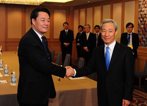 4月24日,日本經(jīng)濟產(chǎn)業(yè)大臣海江田萬里(左)與韓國外交通商部通商交涉本部長金宗塤在東京舉行雙邊會談前握手。新華社記者 季春鵬 攝