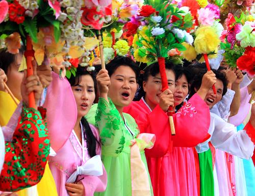8月4日,在朝鮮元山,當(dāng)?shù)厝罕娚泶┟褡迨⒀b、手舉鮮花,在碼頭歡迎中國(guó)海軍訓(xùn)練艦編隊(duì)。新華社記者查春明攝